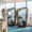 Two blue Loop Solo phone booths sit next to large windows in a modern office