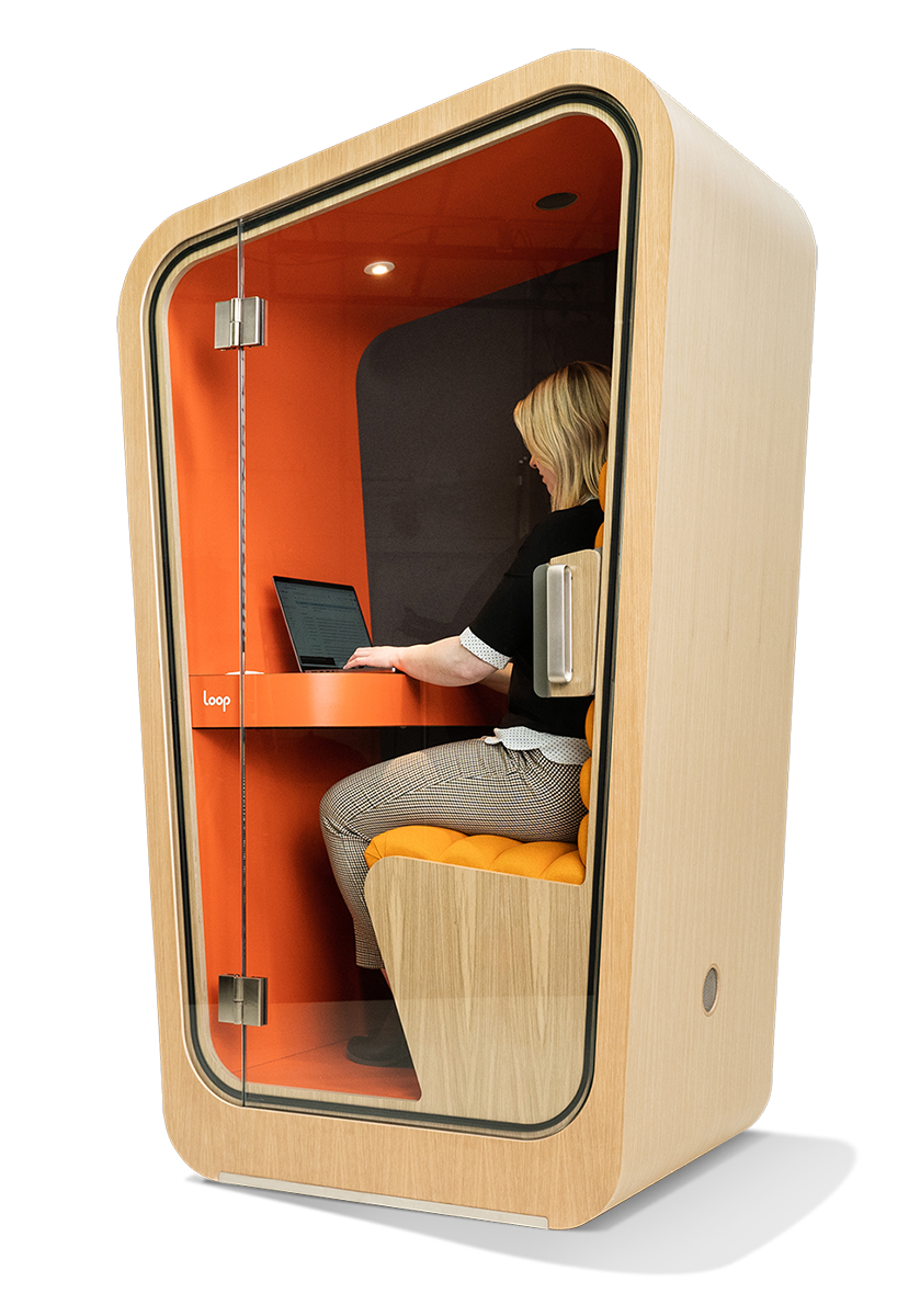 Loop Solo custom build office pod with a woman sitting inside working on a laptop.