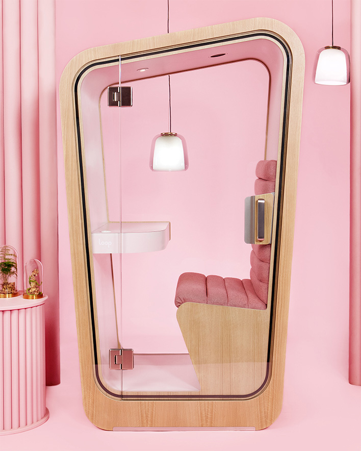 A Loop Solo office pod with a pink interior sits by itself on a pink background