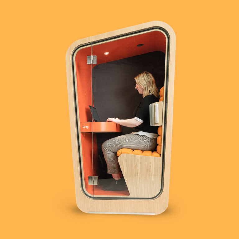 A person works on a computer in a Loop Solo Office pod