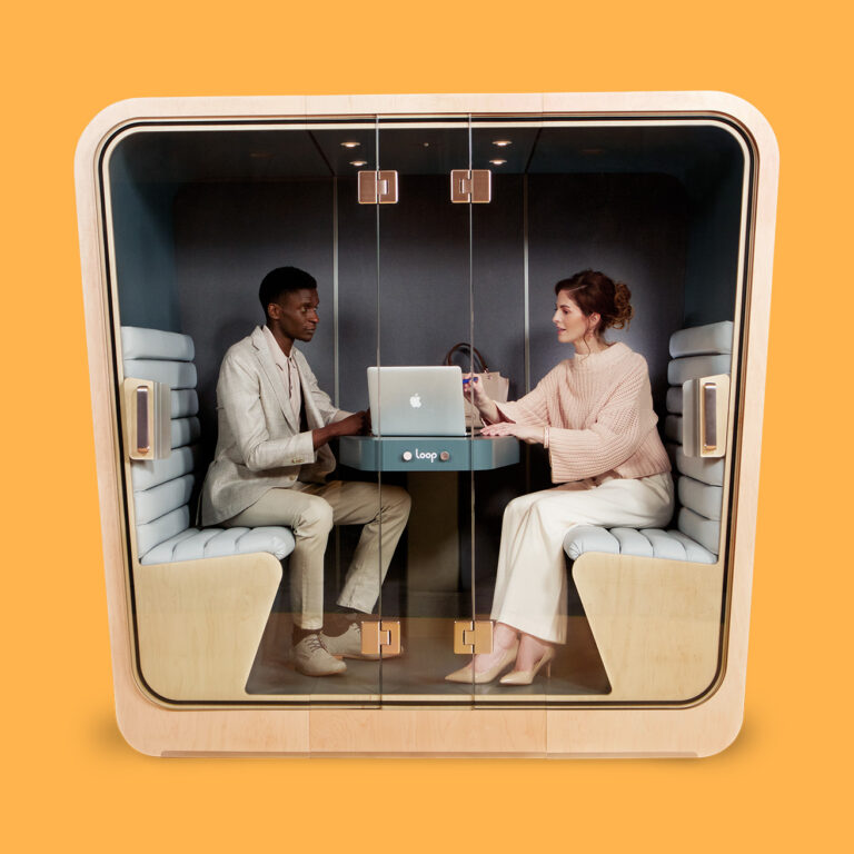 Two people collaborating inside a Loop Cube privacy pod