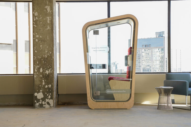 Loop Solo Phone Booth situated in unfinished office overlooking the city