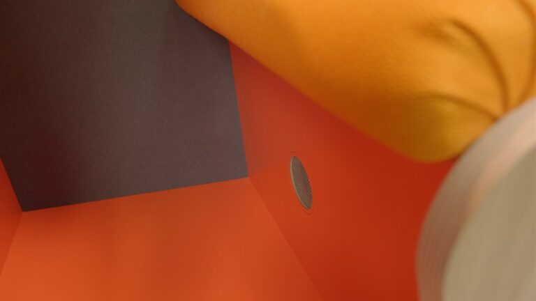 Orange laminate floor of a loop solo office pod with the ventallation showing