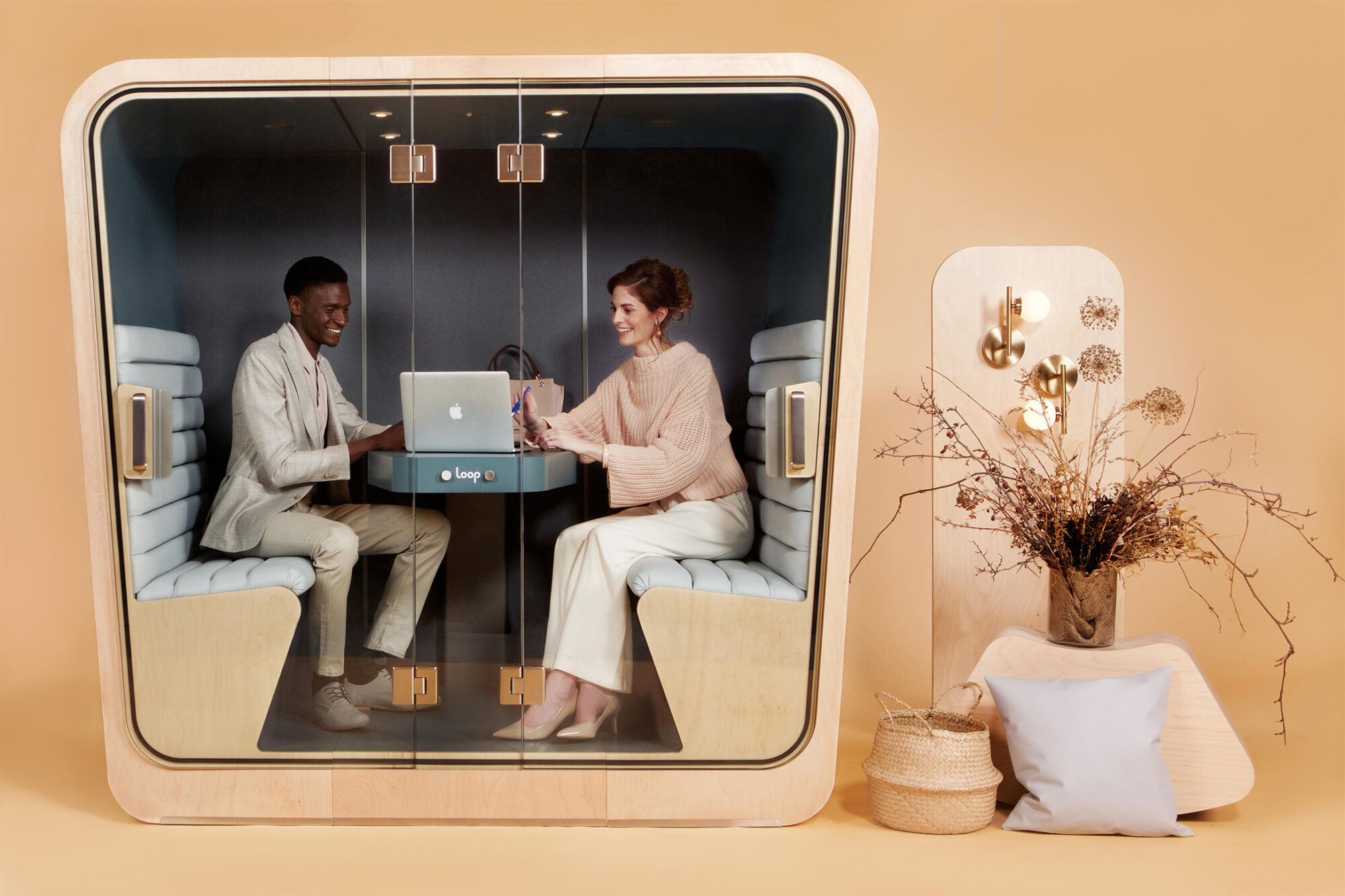 loop cube office meeting pod with two people happily getting work done inside of it